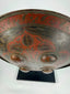 Indo-Persian circular shield with red and black lacquer, raised bosses, and decorative foliate detailing