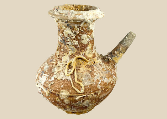 Song Dynasty terracotta wine pot recovered from Balabac Island, Philippines, heavily encrusted with marine deposits, featuring wide rounded body and slender spout, maritime shipwreck artifact