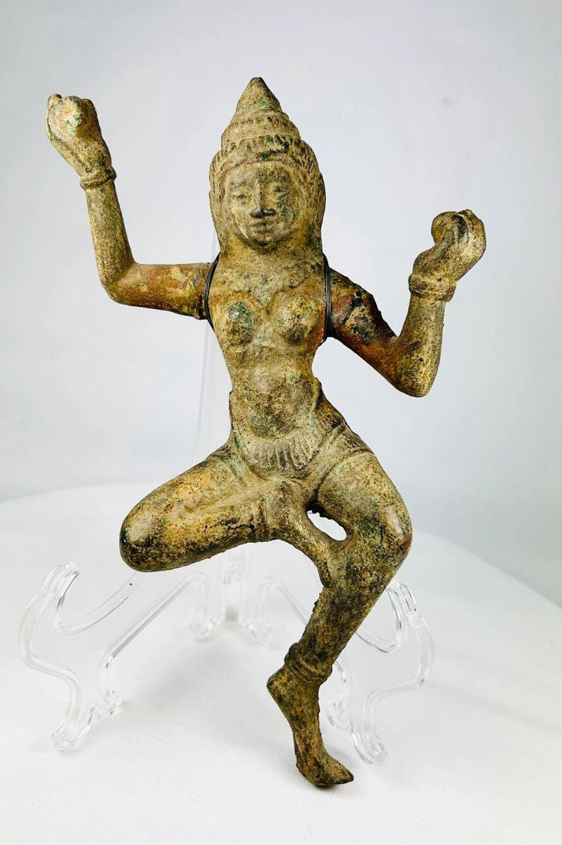 Bronze South Asian sculpture of a dancing deity, likely a Devata or Apsara, with ornate headpiece, flowing attire, and natural green patina, circa 12th–18th century CE.