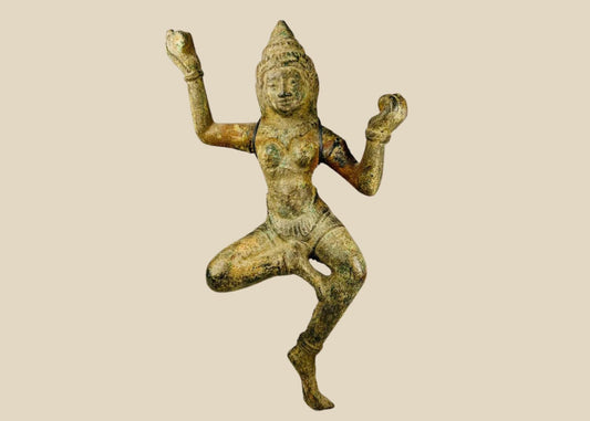 Bronze South Asian sculpture of a dancing deity, likely a Devata or Apsara, with ornate headpiece, flowing attire, and natural green patina, circa 12th–18th century CE.