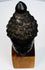 Antique Southeast Asian Buddhist artifact featuring a serene Buddha head with rich dark patina