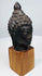 Antique Buddhist bronze head with peaceful facial features and symbolic ushnisha