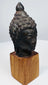 Antique Buddhist bronze head with peaceful facial features and symbolic ushnisha