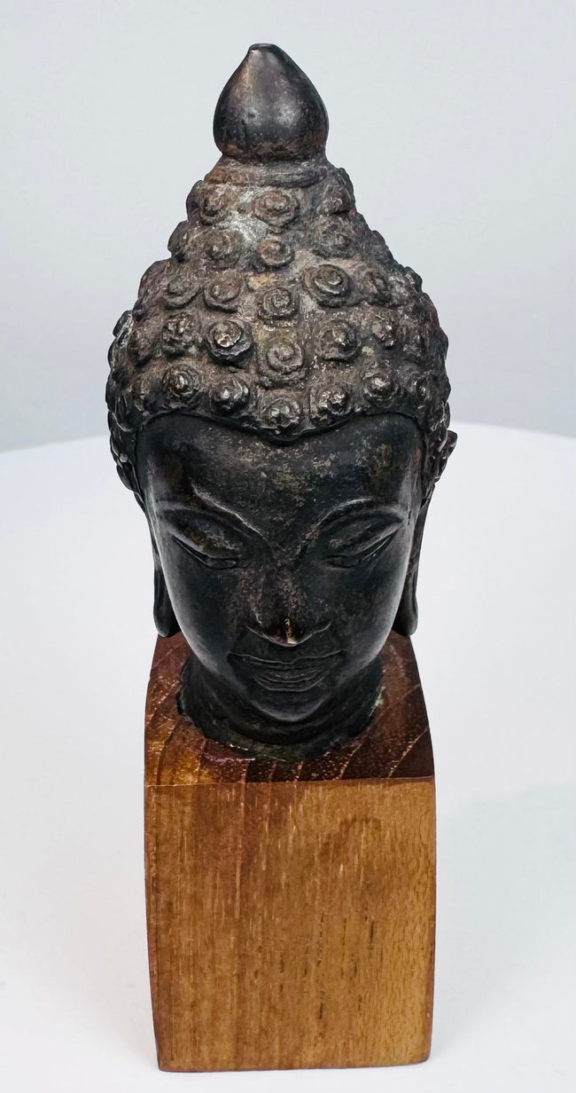 Southeast Asian devotional Buddha sculpture with closed eyes and naturally aged bronze patina