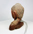 Side profile of Southeast Asian Buddha bust highlighting elongated earlobes and ushnisha.