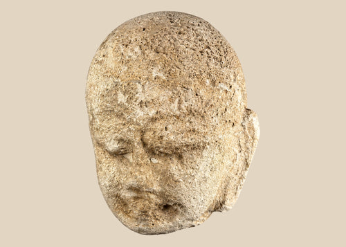 Southeast Asian carved stone Buddha head with serene expression and closed eyes, 13th–14th century, mounted on a modern black stand, Burma or Thailand.