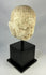 Southeast Asian carved stone Buddha head with serene expression and closed eyes, 13th–14th century, Burma or Thailand, mounted on black display stand.
