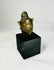 Bronze Buddha head on black base, serene expression, pointed ushnisha, greenish patina, Thailand or Cambodia, 18th–19th century CE