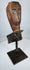 Weathered Southeast Asian ceremonial wood sculpture fragment with stylized protective figure appearance