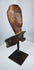 Antique carved wooden mythological figure fragment with natural weathering and age-related cracking