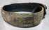 Side view of an antique Jewish ceremonial bridal belt showing its layered brass fittings, gemstone settings, and aged surface wear.