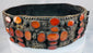 17th–18th century Jewish bridal belt from Southern Russia featuring pierced brass plates and rows of orange Cornelian gemstones.