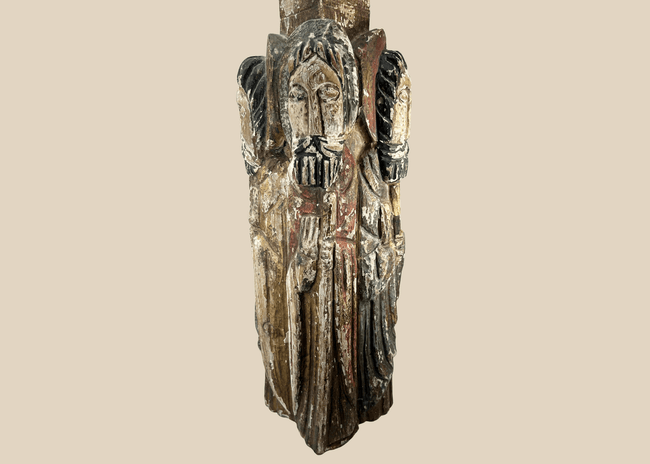 Spanish Colonial carved wooden column with four haloed saint figures and traces of polychrome paint.
