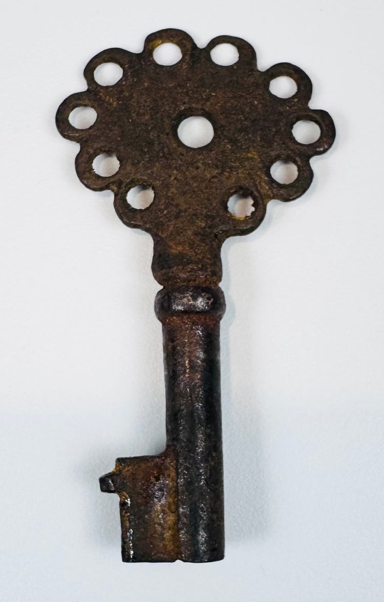 Small Spanish colonial skeleton key with pierced head, defined shank, and centuries-old surface oxidation.