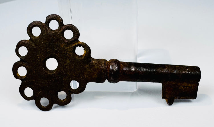 Spanish colonial-era key in oxidized iron, measuring 2.75 inches, with preserved head, shank, and bit.