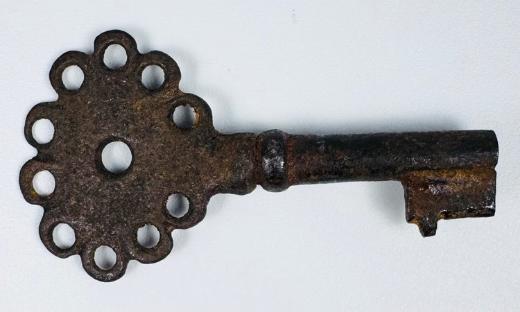 Historic colonial iron key likely used for a chest, door, or secure storage during the Spanish Empire.
