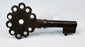 16th–18th century Spanish iron key showing a pierced handle, compact bit, and naturally developed antique patina.
