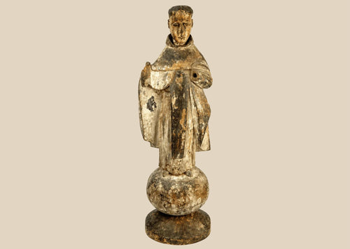 Antique Spanish Colonial santo figure from Latin America (Mexico or Peru), 17th–18th century, carved wood with remnants of polychrome and gesso, depicting a friar or monk in a robe, mounted on an integral rounded base, photographed on a white background.