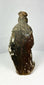Spanish Colonial hand-carved santo statue on pedestal, centuries-old devotional object with gilt and polychrome remnants, rich patina and ritual wear.