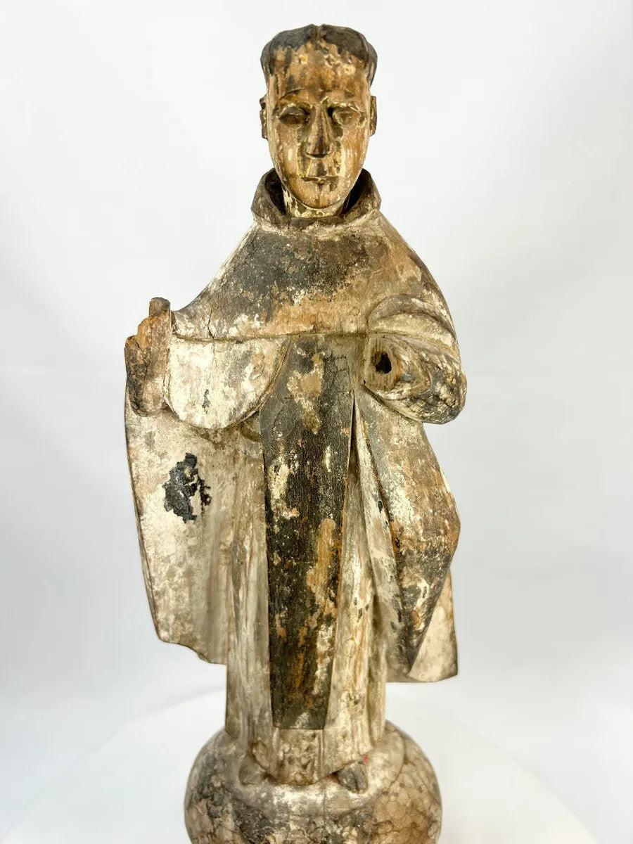 Antique Spanish Colonial santo figure from Latin America (Mexico or Peru), 17th–18th century, carved wood with remnants of polychrome and gesso, depicting a friar or monk in a robe, mounted on an integral rounded base, photographed on a white background.