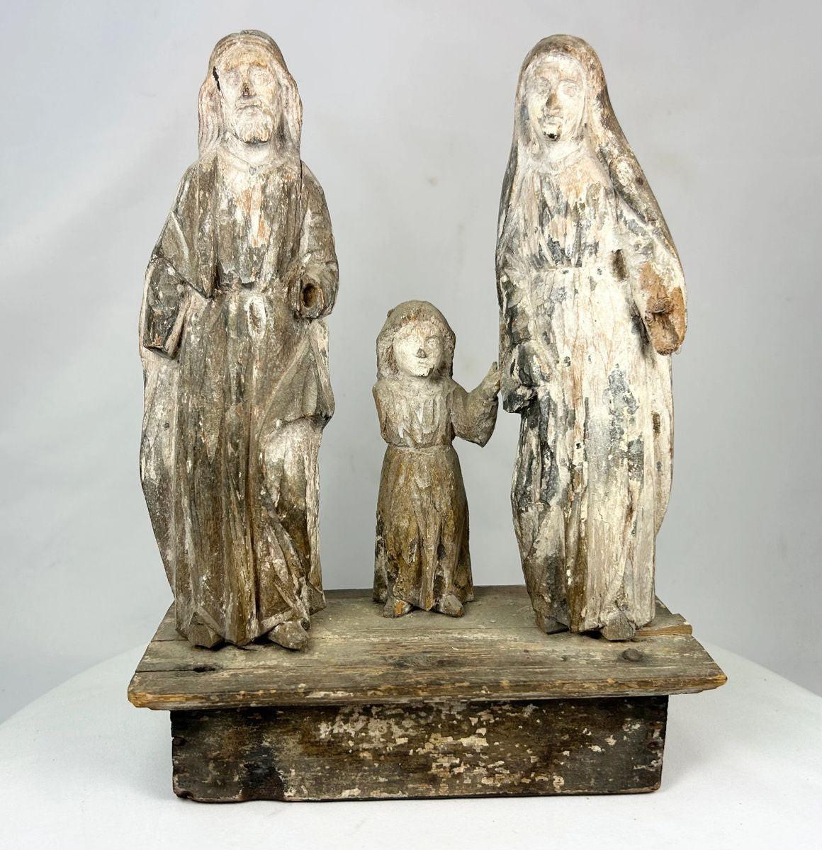 Antique Spanish Colonial Santo sculpture of the Holy Family, 19th century, hand-carved and painted wood figures depicting Joseph, Mary, and Child on a wooden base with aged patina.