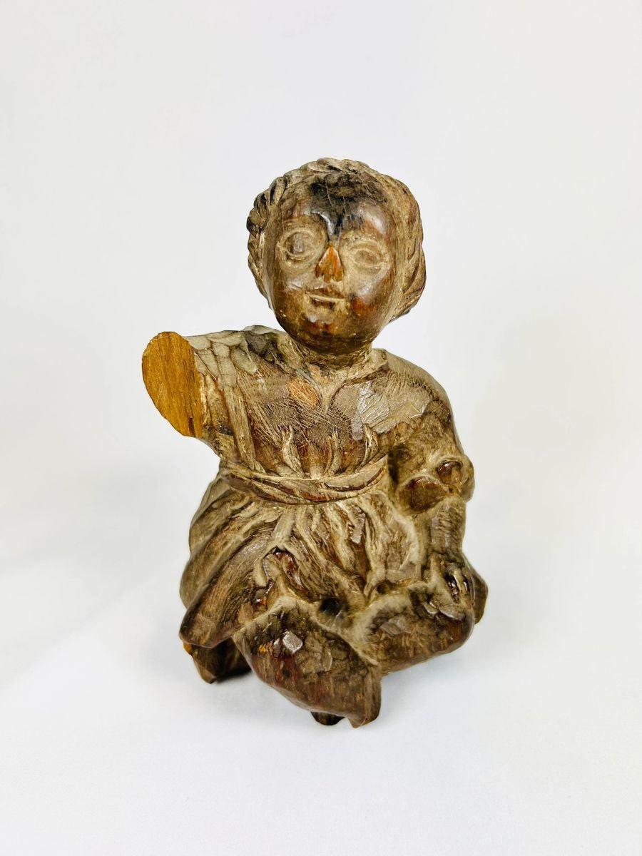 18th–19th century Spanish Colonial wooden figurine of the Christ Child or child saint. Hand-carved folk art style with expressive face, draped clothing, traces of original polychrome, and natural patina. Devotional object reflecting Colonial Latin American religious traditions and daily spiritual practice.