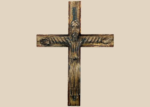 Spanish Colonial carved wooden crucifix depicting Christ with traces of polychrome paint.