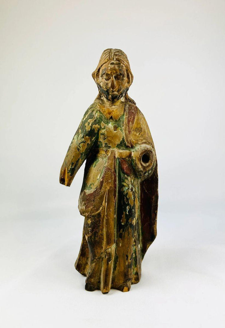 17th–18th century Spanish Colonial wooden statue of a saint or religious figure, hand-carved with flowing drapery and expressive face. Remnants of polychrome paint, surface wear, and a missing arm reflect centuries of devotional use in churches, chapels, or private altars, showcasing Colonial religious artistry.