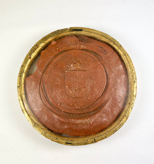 Red wax royal seal of King Philip IV of Spain, circular with detailed enthroned monarch design and Latin inscription, mounted on a white background.