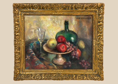 Early 20th-century American oil on canvas still life by John Hubbard Rich, depicting apples, grapes, a wine bottle, and goblet in a giltwood frame, photographed against a white background.