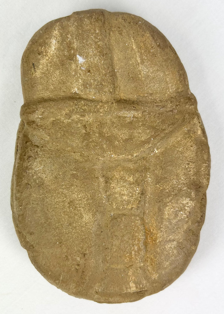 Boldly carved stone face effigy with warrior symbolism and patina