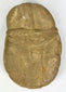 Boldly carved stone face effigy with warrior symbolism and patina