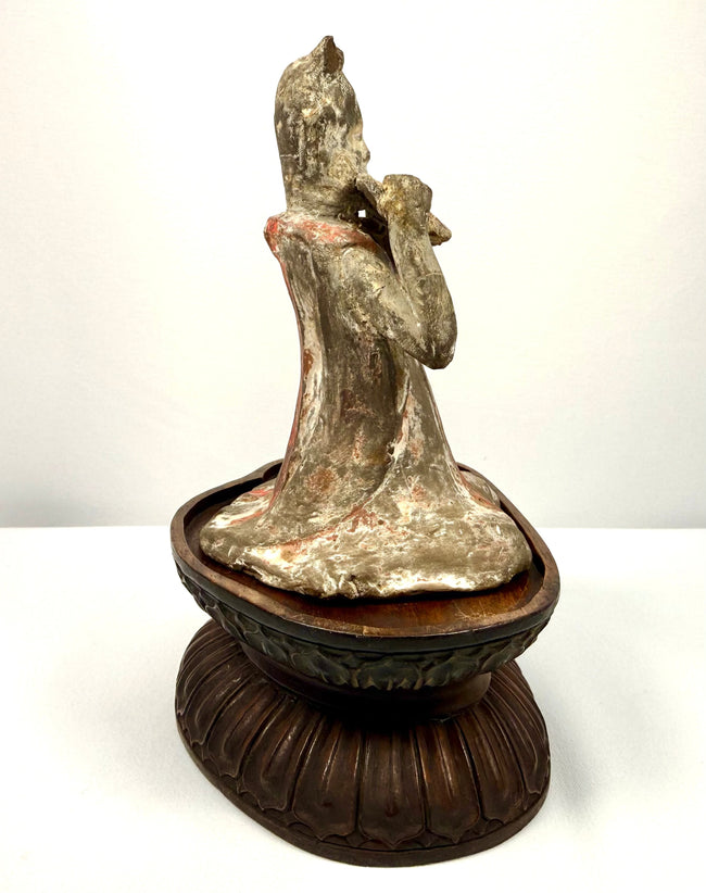 Ancient Chinese female court musician holding a pan flute, mounted on a later-added carved wooden display stand.