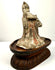 Side profile aged terracotta figurine musician on carved wooden stand