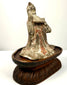 Side profile aged terracotta figurine musician on carved wooden stand