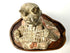 High-angle close-up of ancient terracotta court musician with pigment