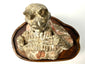 High-angle close-up of ancient terracotta court musician with pigment
