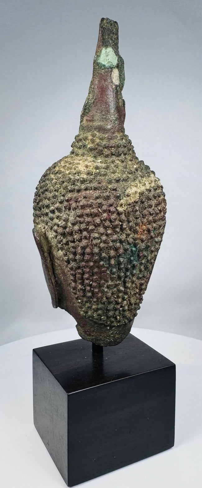 Fourteenth-century Thai Buddha head with almond-shaped eyes and arched brows