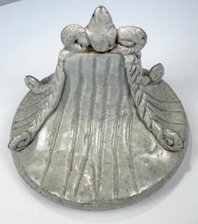 Thai glazed stoneware covered jar with tall finial, ribbed lid, and buff-to-reddish unglazed foot.