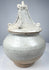 Antique Thai Si Satchanalai covered vessel with pointed architectural finial and applied curling decorative elements.
