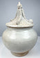 Thai Sawankhalok covered jar with rounded globular body, pale gray-white glaze, and ornate pointed lid.
