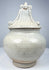Early Thai covered stoneware jar attributed to Sawankhalok kilns with ornate fitted lid and aged glaze crazing.