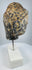 Southeast Asian Buddhist stone sculpture with serene face, aged patina and pigment traces