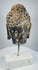 Antique Buddhist sculpture from Southeast Asia with remnants of dark and ochre pigment