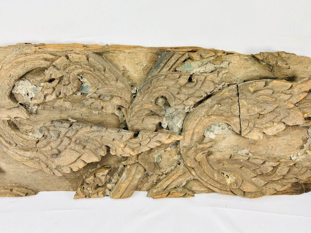 17th-century Thai Ayutthaya carved wooden temple fragment with flowing motifs, remnants of gilding, and symmetrical sacred design.