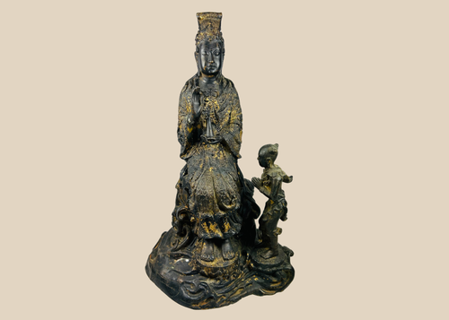 Front view of Thai cast bronze Guanyin with child attendant seated on lotus pedestal, showing traces of original gold gilding.