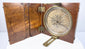 Open mid-19th-century Thomas Jones Liverpool alidade compass in its walnut case, showing the circular silvered degree ring and brass sighting arms.