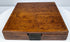 Closed walnut case of a mid-19th-century Thomas Jones surveying compass showing its figured wood grain and aged surface patina.