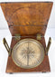 Angled photograph of the Thomas Jones alidade compass showing the walnut case, compass dial, brass fittings, and open lid.