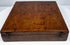 Opposite exterior angle of the walnut instrument case showing its low rectangular profile, hinged construction, and 19th-century surface wear.